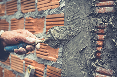 Home bricklaying. construction worker building a brick wall.